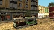 The tram is white with bright green stripes  миниатюра 3